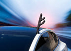 Car with a reindeer antler decoration against a blurred motion background
